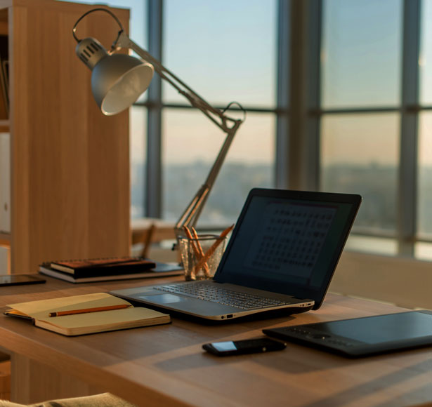 Work desk with a laptop representing the Popway workplace at a leading software agency.