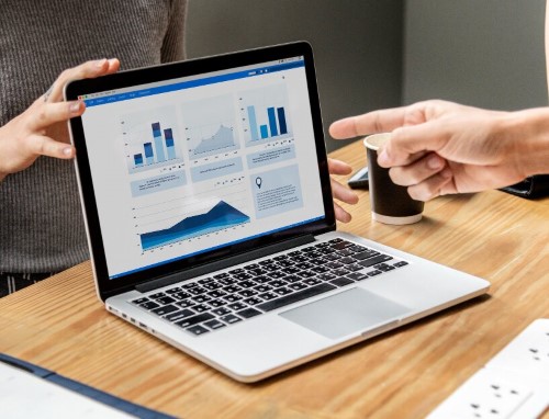 CRM and customer retention analysis on an ERP report laptop screen focusing on customer retention and acquisition in CRM.