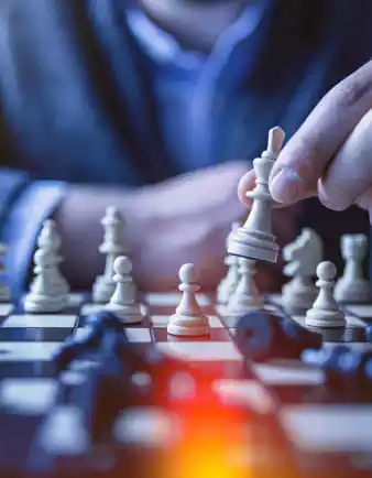 Person with chess board beating opponent representing successful projects of web development